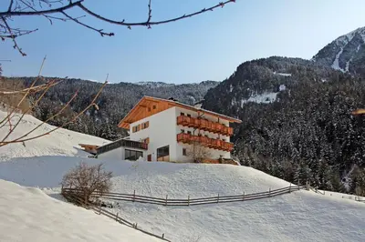 a building on top of a snow covered mountain at Obererhof in SantʼAndrea in Monte
