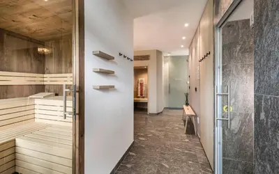 a bathroom with a walk in shower and a walk in closet at Vinea - Apartments in Tirolo