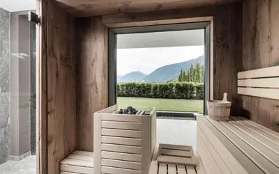 a bathroom with a tub and a window with a view at Vinea - Apartments in Tirolo