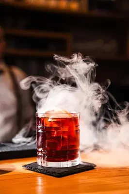 a smoke filled drink sitting on a table at Hotel Panoramic Lotsch in Sarntal
