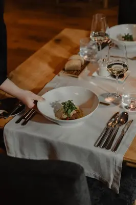 a table with a plate of food on a table at Hotel Panoramic Lotsch in Sarntal