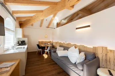 a living room with a couch and a table at Le Suite della nonna Teresina in Moena