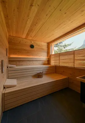 a sauna with a bench in a wooden room at Charme Hotel Uridl in Santa Cristina in Val Gardena