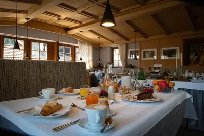 a table with breakfast foods and coffee on it at Charme Hotel Uridl in Santa Cristina in Val Gardena