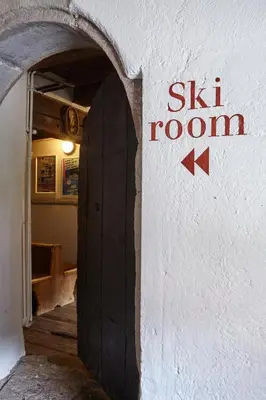 a building with a sign that says ski room at Charme Hotel Uridl in Santa Cristina in Val Gardena