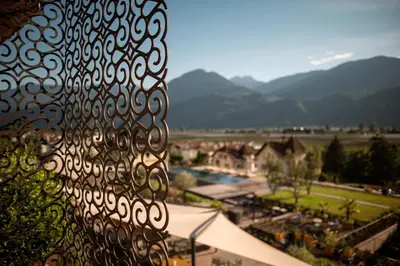 a view of a resort with a pool and mountains at Muchele Boutique Hotel in Postal