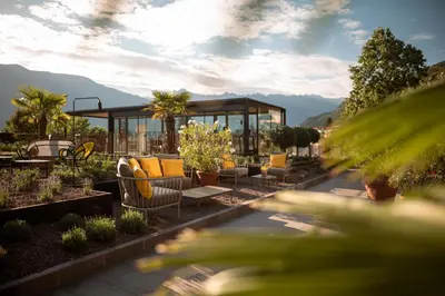 a patio with a gazebo and chairs and plants at Muchele Boutique Hotel in Postal