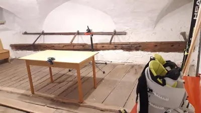 a room with a table in the middle of a room at Casa Trettel in Tesero