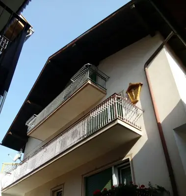 a building with balconies on the side of it at Casa Trettel in Tesero