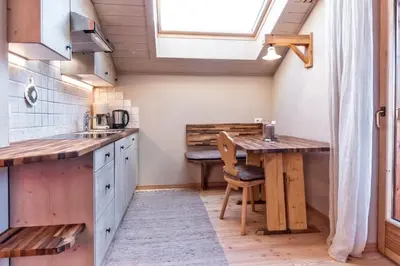 a small kitchen with a table and a window at Widmannhof - Urlaub auf dem Biobauernhof in Bressanone