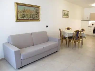 a living room with a couch and a table at Appartamenti Stefan in Campitello di Fassa