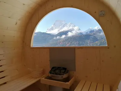 a window in a wooden room with a mountain at Hotel il Cardo in San Vito di Cadore