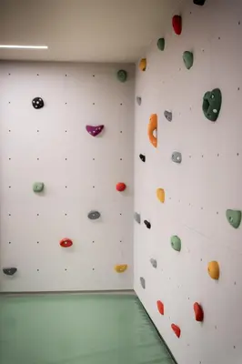 an indoor bouldering wall in a climbing gym at The Oswald Grand Hotel in Selva di Val Gardena