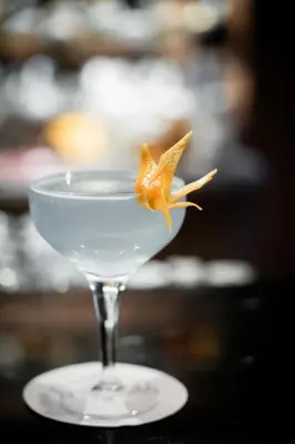 a martini glass with a gold star on a table at The Oswald Grand Hotel in Selva di Val Gardena