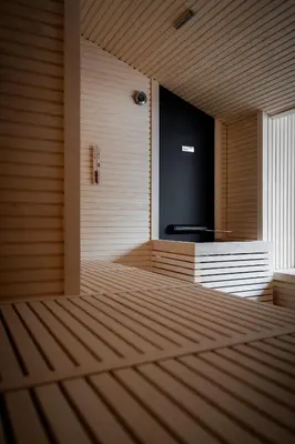 a empty room with a large television in the wall at The Oswald Grand Hotel in Selva di Val Gardena