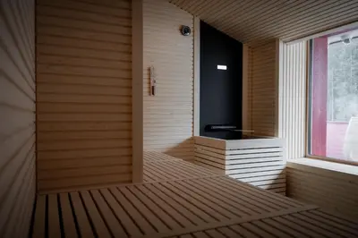 a room with a sauna with a window at The Oswald Grand Hotel in Selva di Val Gardena