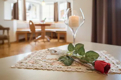 a wine glass sitting on top of a table at Residence Diamant in Castelrotto