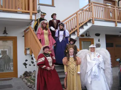 a group of people dressed in costumes standing on stairs at Agriturismo Pisani in Brez