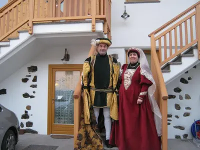 two people dressed in costumes standing under a staircase at Agriturismo Pisani in Brez