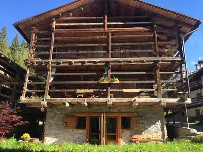 a wooden house with a balcony on top of it at Chalet nel cuore delle Dolomiti in Falcade