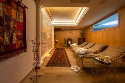 a hallway with two beds and a rug at Hotel Luis in Fiera di Primiero