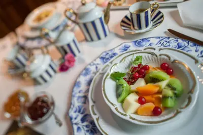 a bowl of fruit and vegetables on a table at Hotel Luis in Fiera di Primiero