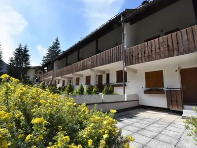 a building with yellow flowers in front of it at Apartment Monti Pallidi by Interhome in Campitello di Fassa