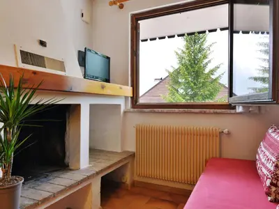 a living room with a fireplace and a tv at Apartment Monti Pallidi by Interhome in Campitello di Fassa