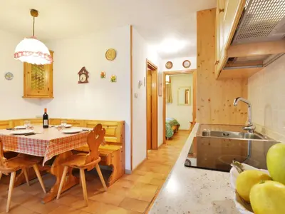 a kitchen with a table with chairs and a sink at Apartment Monti Pallidi by Interhome in Campitello di Fassa