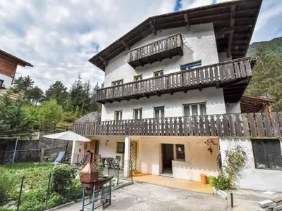 a building with a mural on the side of it in the snow at Apartment La Busa-3 by Interhome in Alleghe