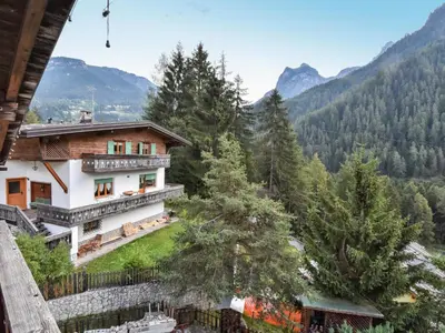 a building with a painting on the side of it in the snow at Apartment La Busa-3 by Interhome in Alleghe