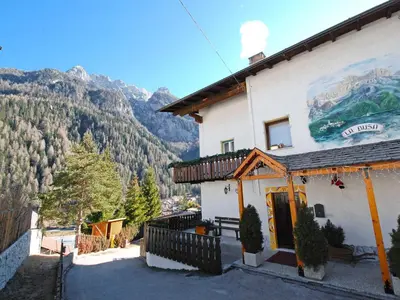 a building with a sign on it in the snow at Apartment La Busa-3 by Interhome in Alleghe