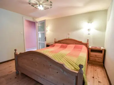a bedroom with a bed with a colorful blanket on it at Apartment La Busa-3 by Interhome in Alleghe