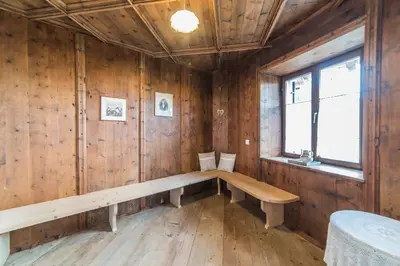 a wooden room with a bench and a window at Jagerhof in Caldaro
