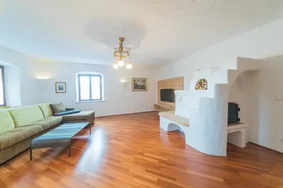 a living room with a couch and a fireplace at Jagerhof in Caldaro