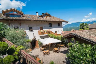 an external view of a house with an umbrella at Jagerhof in Caldaro