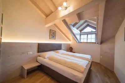 a bedroom with a bed and a skylight at Jagerhof in Caldaro