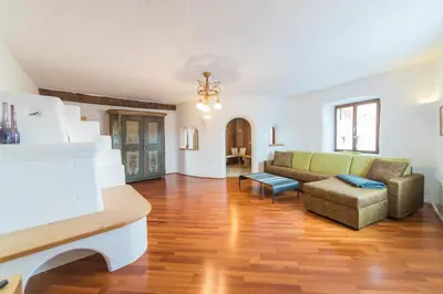 a living room with a couch and a chair at Jagerhof in Caldaro