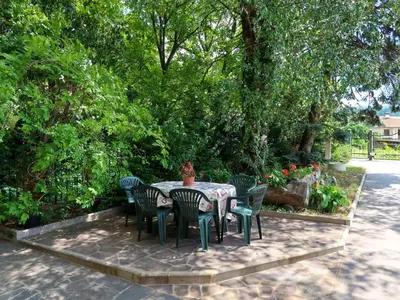 a table and chairs with a potted plant on it at Apartment Pancheri by Interhome in Coredo