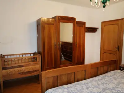 a bedroom with a bed and a dresser and a mirror at Apartment Pancheri by Interhome in Coredo
