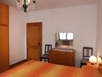 a bedroom with a bed and a dresser and a mirror at Apartment Pancheri by Interhome in Coredo