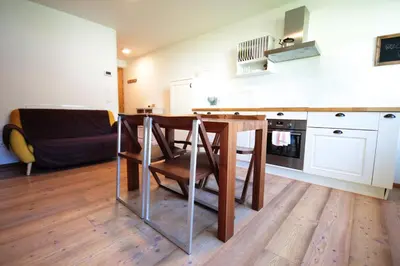 a kitchen with a table and a dining room at Aurturist Valdaora Roulette in Valdaora