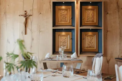 a dining room with a table with glasses on it at Hotel Digon in Ortisei