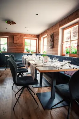 a large dining room with a long table and chairs at Hotel Digon in Ortisei