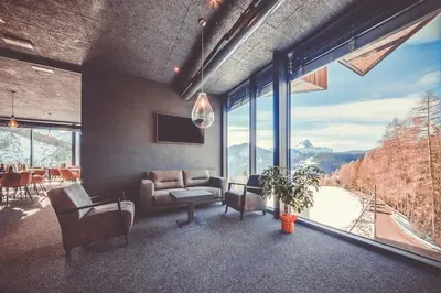 a living room with a view of a mountain at Spaces Hotel in San Vigilio Di Marebbe