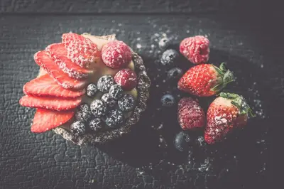 a plate of fruit with strawberries and blueberries at Spaces Hotel in San Vigilio Di Marebbe