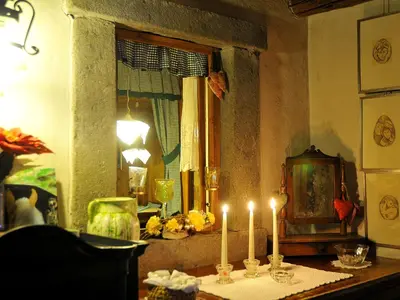 two candles on a table in a room with a window at Hotel Belvedere wellness in Falcade