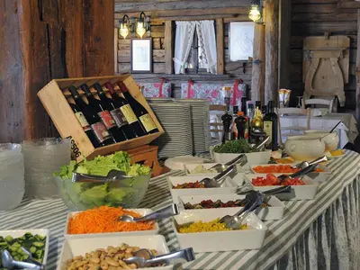 a table topped with lots of food and bottles of wine at Hotel Belvedere wellness in Falcade