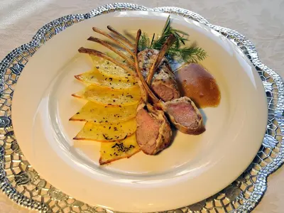 a plate of food with meat and fruit on a table at Hotel Belvedere wellness in Falcade