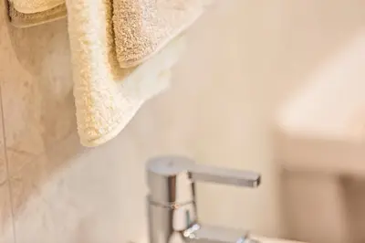 a bathroom with a sink and a towel at Apartments Milanhof in Ortisei